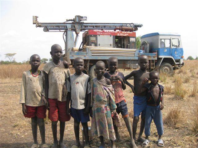 Children at a water well site drilled by Y.E.T. Compassion in Biong
